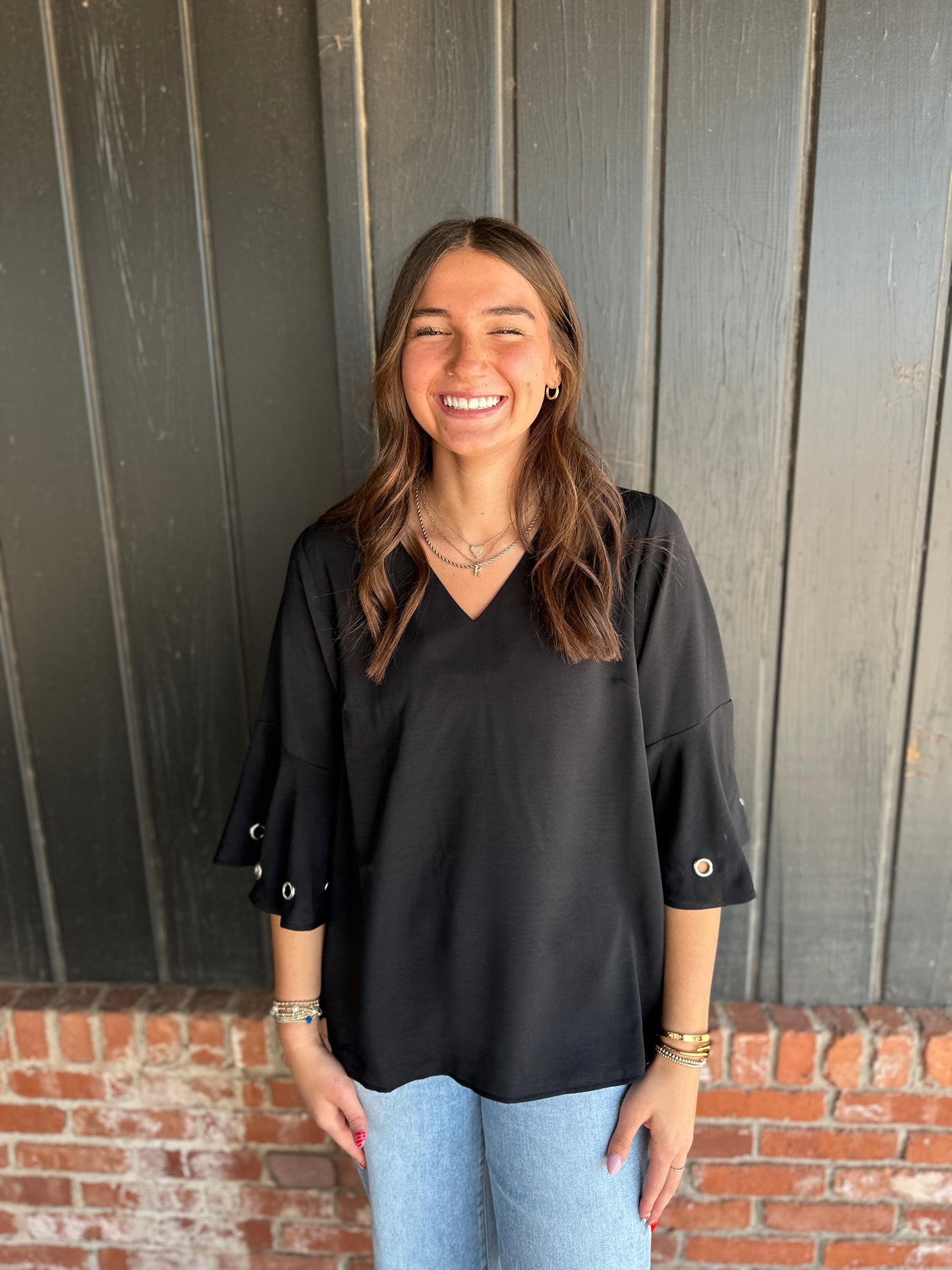 Black three quarter sleeve top with eyelet detail