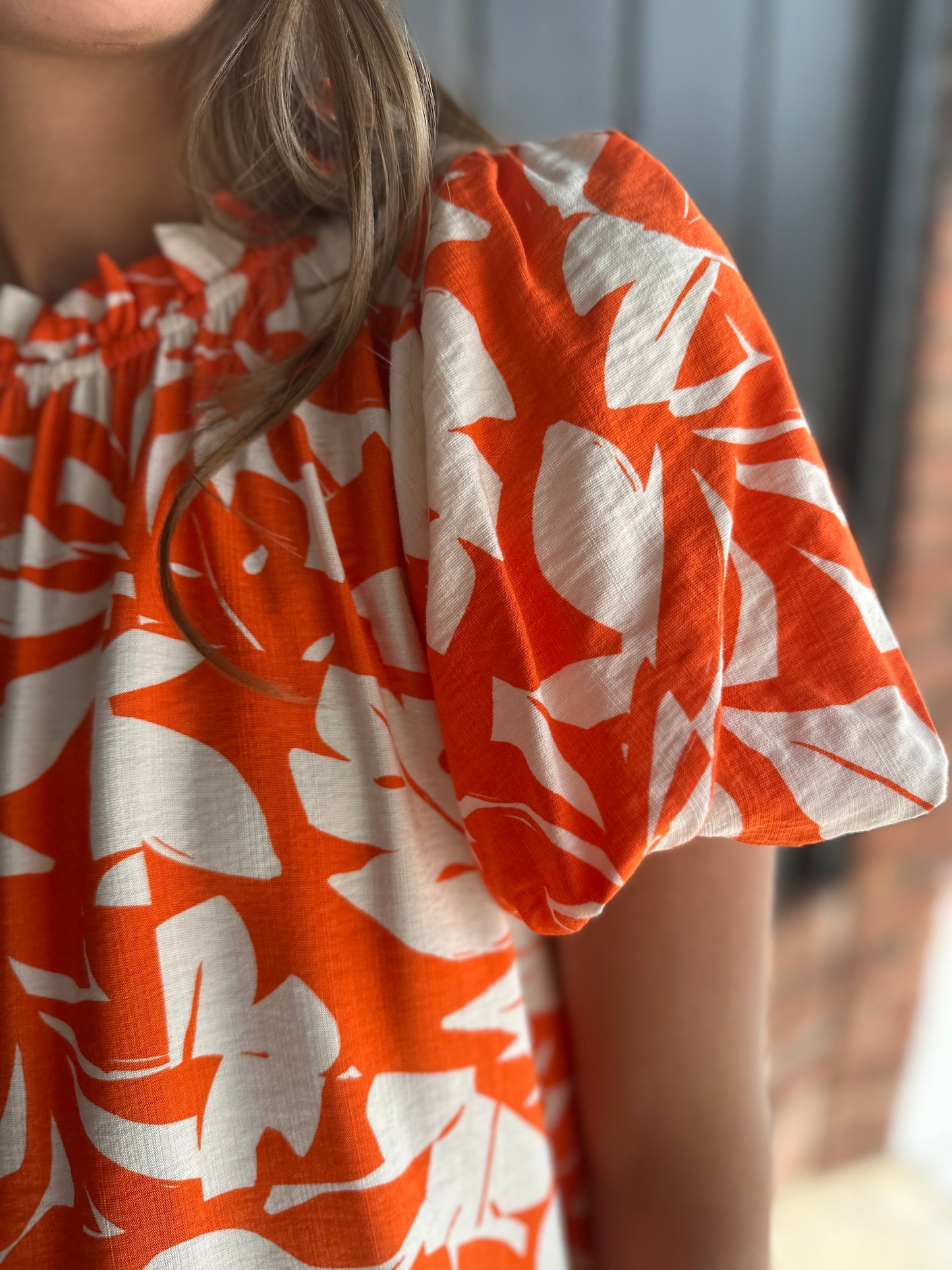 Orange print frilled neck top